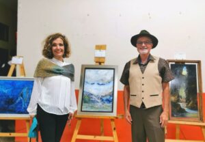Aurelia Dobles y Danilo Pérez, junto a la pintura de Alejandro Villegas que fue portada de poemario. Foto por Emily Solórzano